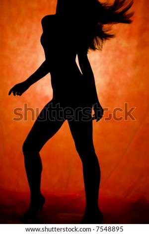 woman dance, silhouette in front of orrange background
