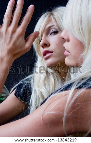 blond woman in the mirror, focus in the mirror face