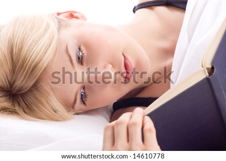 woman reading a book in bed