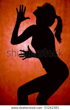 woman dance, silhouette in front of orrange background