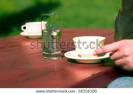 woman hand picking up cup of coffee