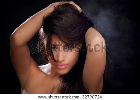 young beautiful woman with hands in hair