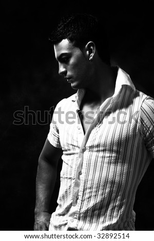 stock photo young handsome man black and white portrait studio shot