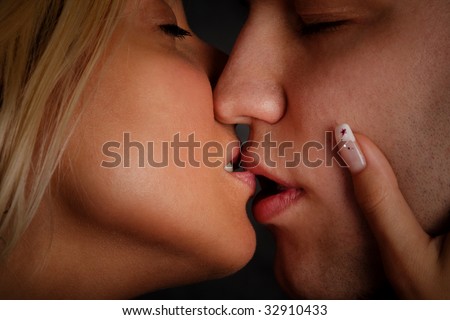 couple of young lovers kissing, close up, studio shot