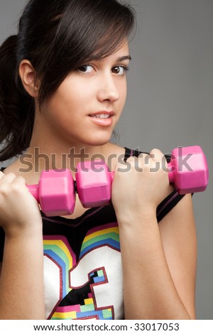 stock photo pretty teen girl workout with hand waight studio shot