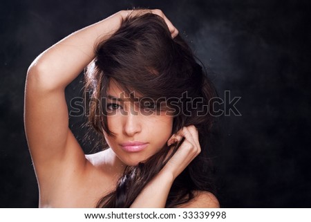 young woman with hands in hair