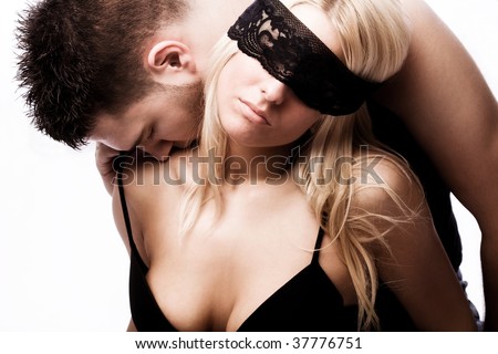 young masked couple in love, studio shot on white