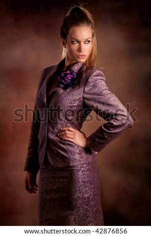 young blond woman in elegant clothes studio shot