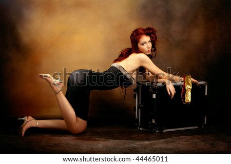 stock photo : beautiful red hair woman in sexy dress leaned on trunk, 