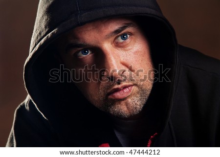 adult handsome man with hood portrait, studio shot
