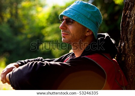 adult man resting in nature, spring day forest