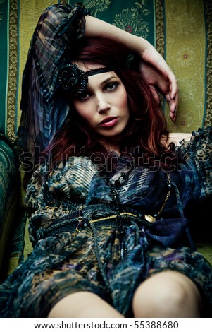 beautiful fashion rd hair woman in arm chair, indoor shot