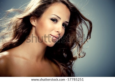 beauty portrait of young brunette woman, hair fly, studio shot