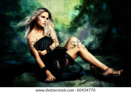 Young woman in black studio shot fantasy background