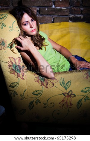 young woman  sit in armchair feeling depressed, indoor shot