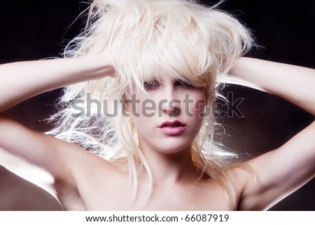 blond woman with hands in hair