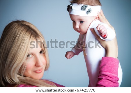 mother hold her baby girl   studio shot