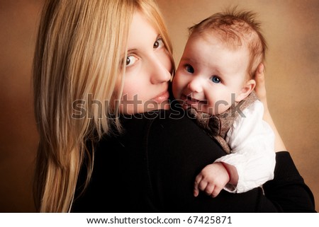 young mother hold her baby girl   studio shot