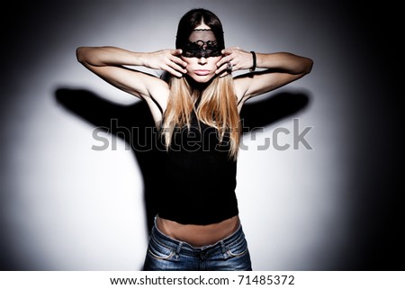 blond woman with black lace over eyes portrait, hands on face, studio shot, horizobtal