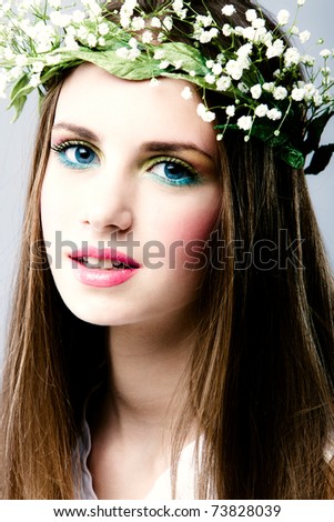 young blue eyes blond woman beauty portrait with wreath of flowers