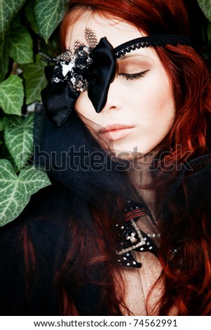 red hair fashion woman outdoor portrait with decorative bow over eye