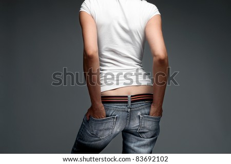 woman wearing blue jeans and white t shirt, back, studio shot