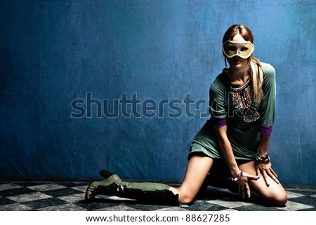 beautiful woman with carnival mask posing on floor,  full body shot, indoor shot