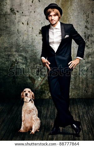 handsome  young  man in tuxedo and his dog in  grunge room