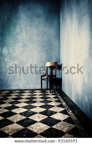 Grunge Room With Blue Old Walls Tiled Floor And Wooden Chair In Corner