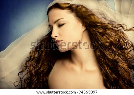 young woman with veil, long curly hair, eyes closed, head in profile, small amount of grain added