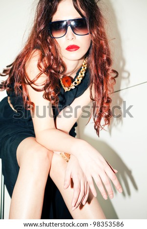 modern redhead young woman portrait with sunglasses, indoor shot