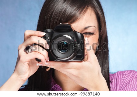 girl take a photo with digital camera
