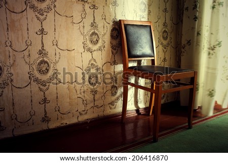 the old chair rubbed from time costs in the room