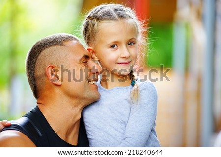 the father embraces the daughter and they together enjoy life