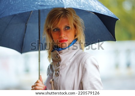 the girl with a black umbrella costs in the rain