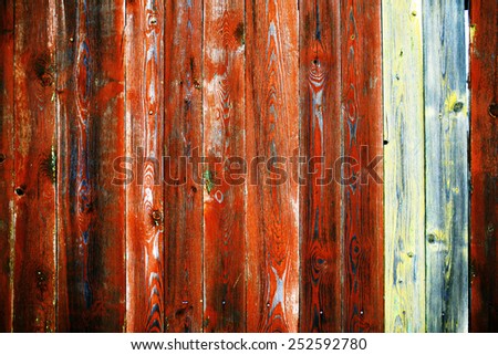 old wooden fence in the cracked paint from time to time