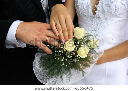stock photo Wedding flowers and hands of a newlymarried couple with 