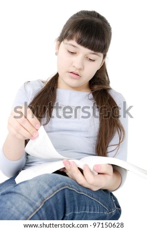 The girl the teenager reads the book on the isolated white background