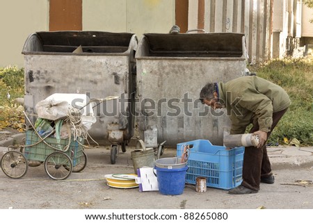 A homeless man collecting garbage