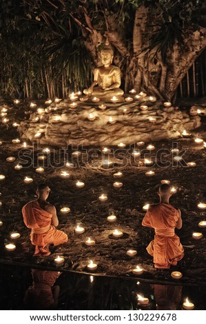 CHIANG MAI THAILAND-FEBRUARY 25 : Makha Bucha Day.Traditional buddhist monks are lighting candles for religious ceremonies at Wat Phan Tao temple.on FEB. 25,2013 in Chiangmai,Thailand