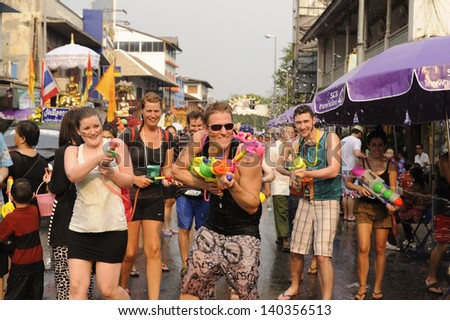 CHIANG MAI THAI-APRIL 13:Chiangmai Songkran festival.Unidentified men and women traveler Like to join the fun with splashing water at Tha Pae road.on April 13,2013 in Chiangmai,Thailand.