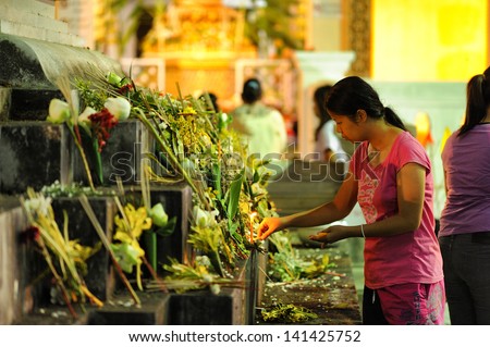 CHIANG MAI THAILAND-JUNE 5 : Inthakhin traditional Offerings of flowers.Unidentified woman are offering flower to the traditional city pillar at Chedi Luang temple.on June 5,2013 in Chiangmai Thailand