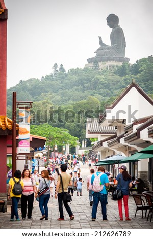 HONGKONG , CHINA-JULY 7 : Tourists come to pray to Buddha the largest. It is important to come to Hong Kong. at NGONG PING hill on July 7,2014 in Hong Kong.