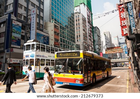 HONG KONG , CHINA - JULY 8 : Transportation system of Hong Kong with the electric trams. Private car and bus. on July 8,2014 in Hong Kong.