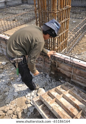 Man working at site construction. Photo Show is a template to place the concrete beam only.