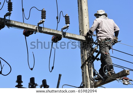 Electrician Man on electric poles. Electrical repairs are made to restore them to normal.