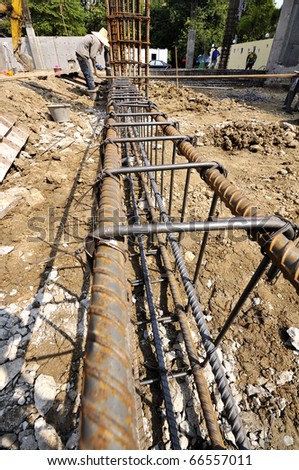 Steel deformed bars. Image shows the structure of cast concrete beams. Workers help each other harmoniously