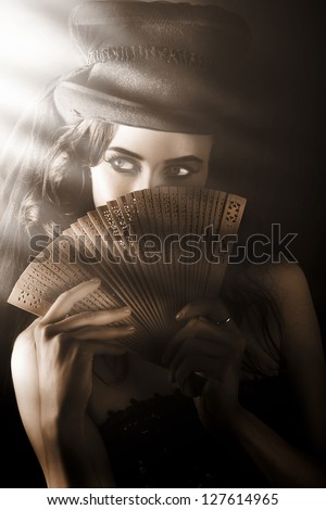 Broadway Entertainer Holding Vintage Wooden Fan While Looking Into The Stage Spotlight In A Depiction Of A Cabaret Theatre Show