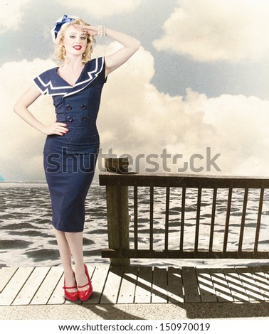 Fine Art Photo Of A Beautiful Young Pin-Up Woman With Vintage Make-Up And Blond Hairstyle Saluting On Vacation Departure Dock