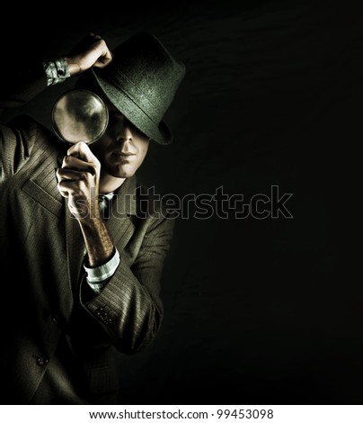 Creative Grunge Portrait Of A Man Holding A Magnifying Glass While On A Search And Find Mission To Solve A Crime Scene Investigation, Isolated On Black